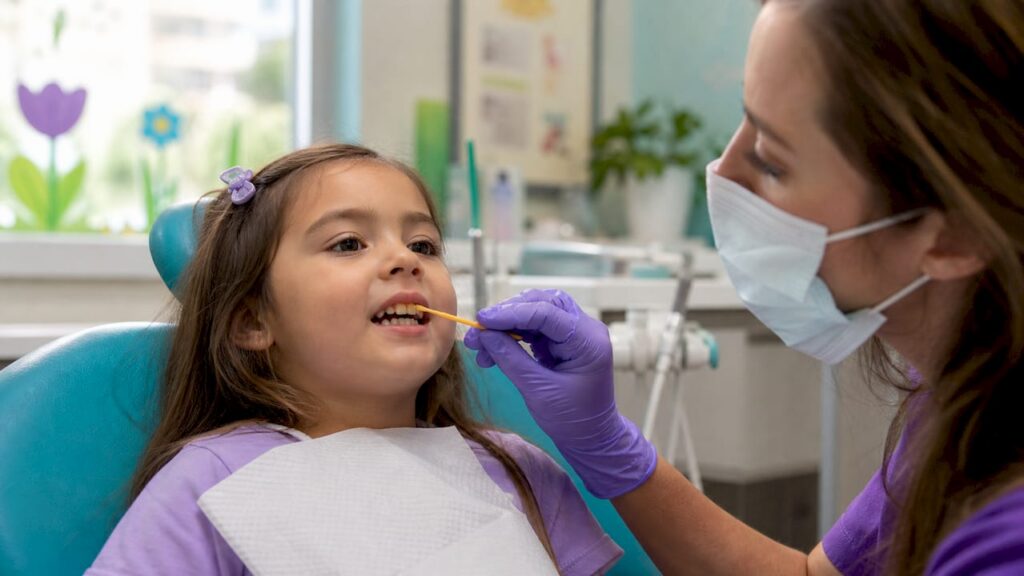 Child receiving fluoride varnish on teeth