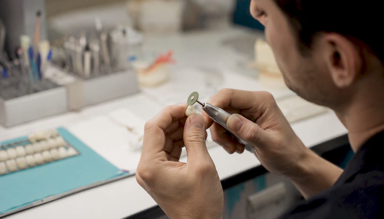 Dental crown chip being polished by dentist