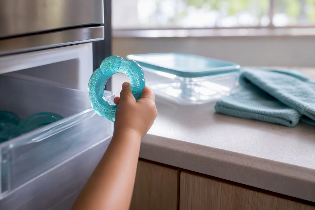 Child holding a chilled teething ring